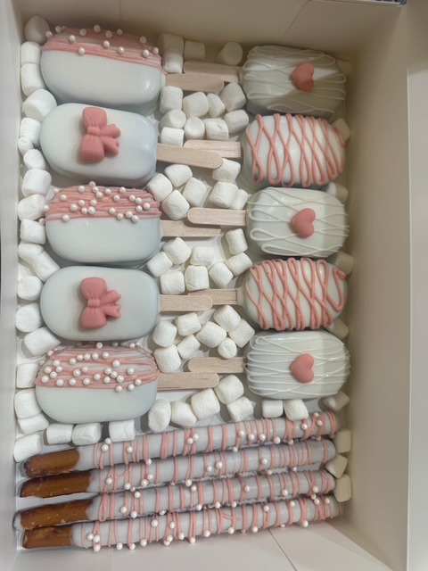 Pink and white cakecicles and dipped pretzels by Katalina