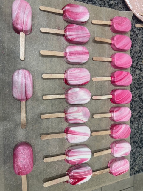 Pink marbled cake pucks and cakecicles on sticks by Katalina